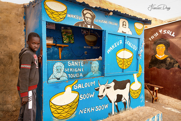 Senegalese boy at a milk and yogurt stall